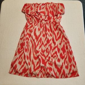 Bee Stitched women's orange print mini dress. Strapless ruffle chest.